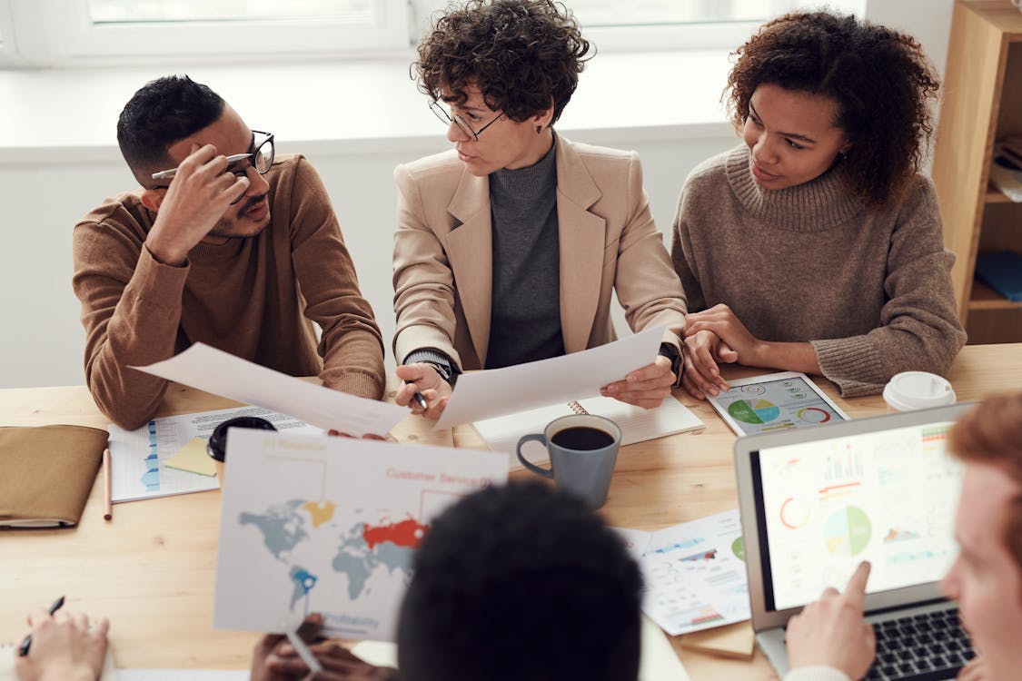 Consultants reviewing reports and dashboards with a client